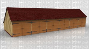 This oak framed six bay garage block is for the use of three different properties and they each have two garages each. The building has gable ends and a rear catslide to keep the ridge below 4m but still give a usable depth of garage inside. Each garage is secured at the front with a pair of traditional side hung garage doors.