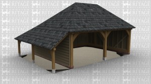 An oak frame 2 bay open ended garage with a slate roof as well as an outside log store