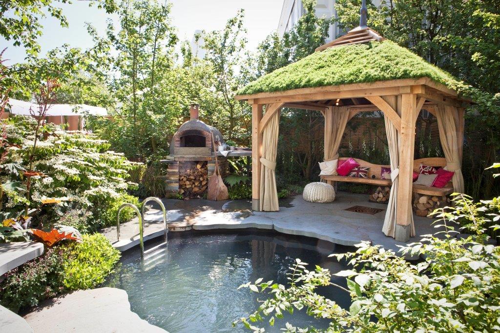pergola by a small pool, with a mossy roof