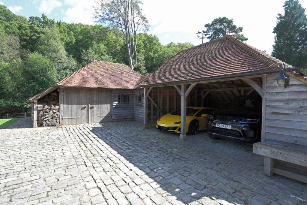a 2 bay garage with a luxury car parked inside