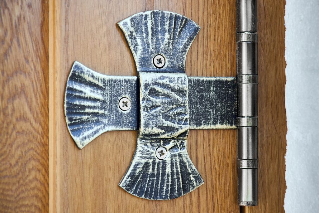 forged iron door hinge in a cross shape